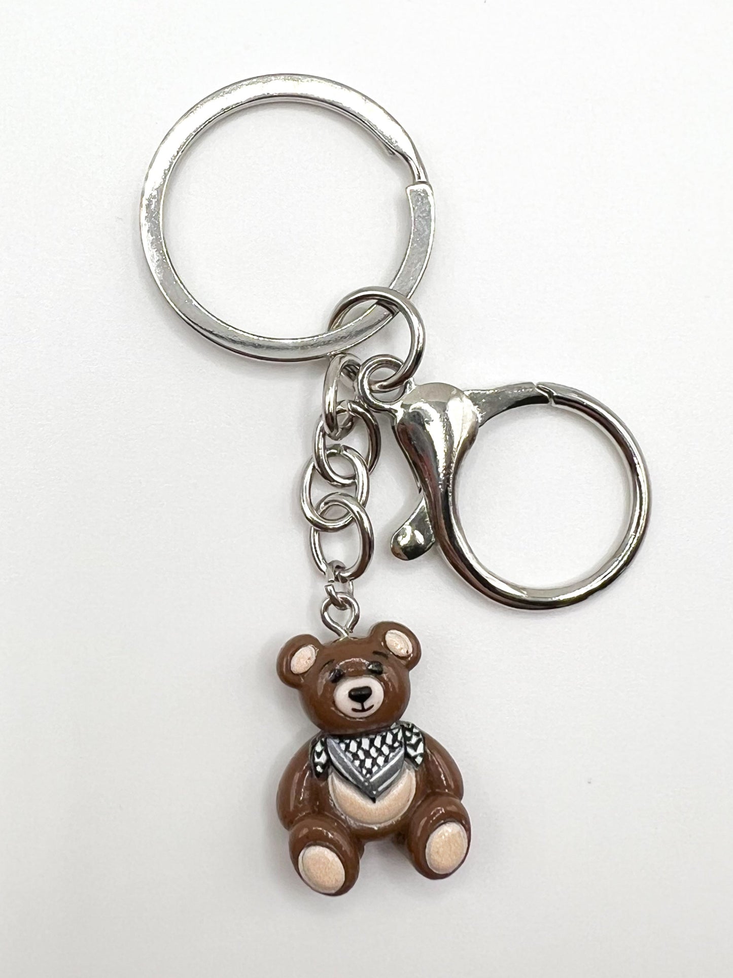 Keychain with a keffiyeh teddy bear charm on a white background