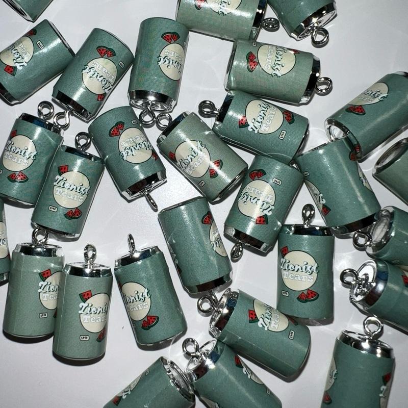 Collection of green can-shaped keychains with 'zionist tears' branding on a white background