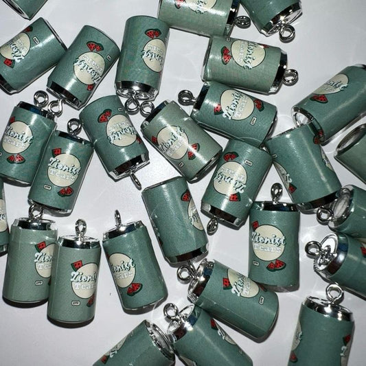 Collection of green can-shaped keychains with 'zionist tears' branding on a white background
