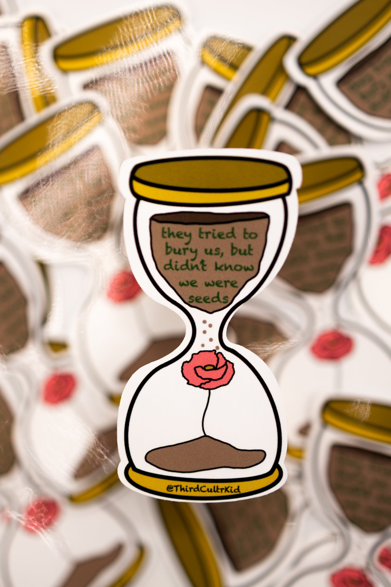 Sticker of an hourglass with a poppy flower