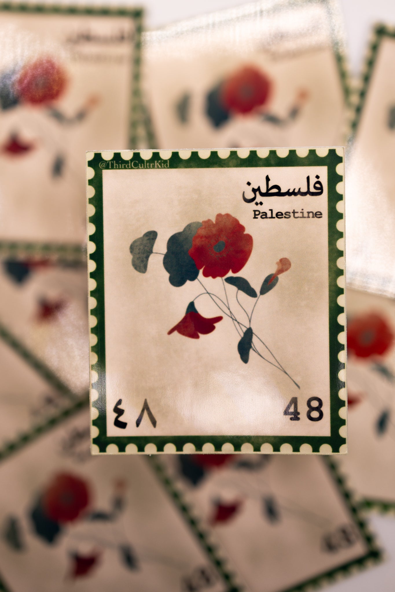 Stylized postage stamp with floral design and text 'Palestine' on a blurred background