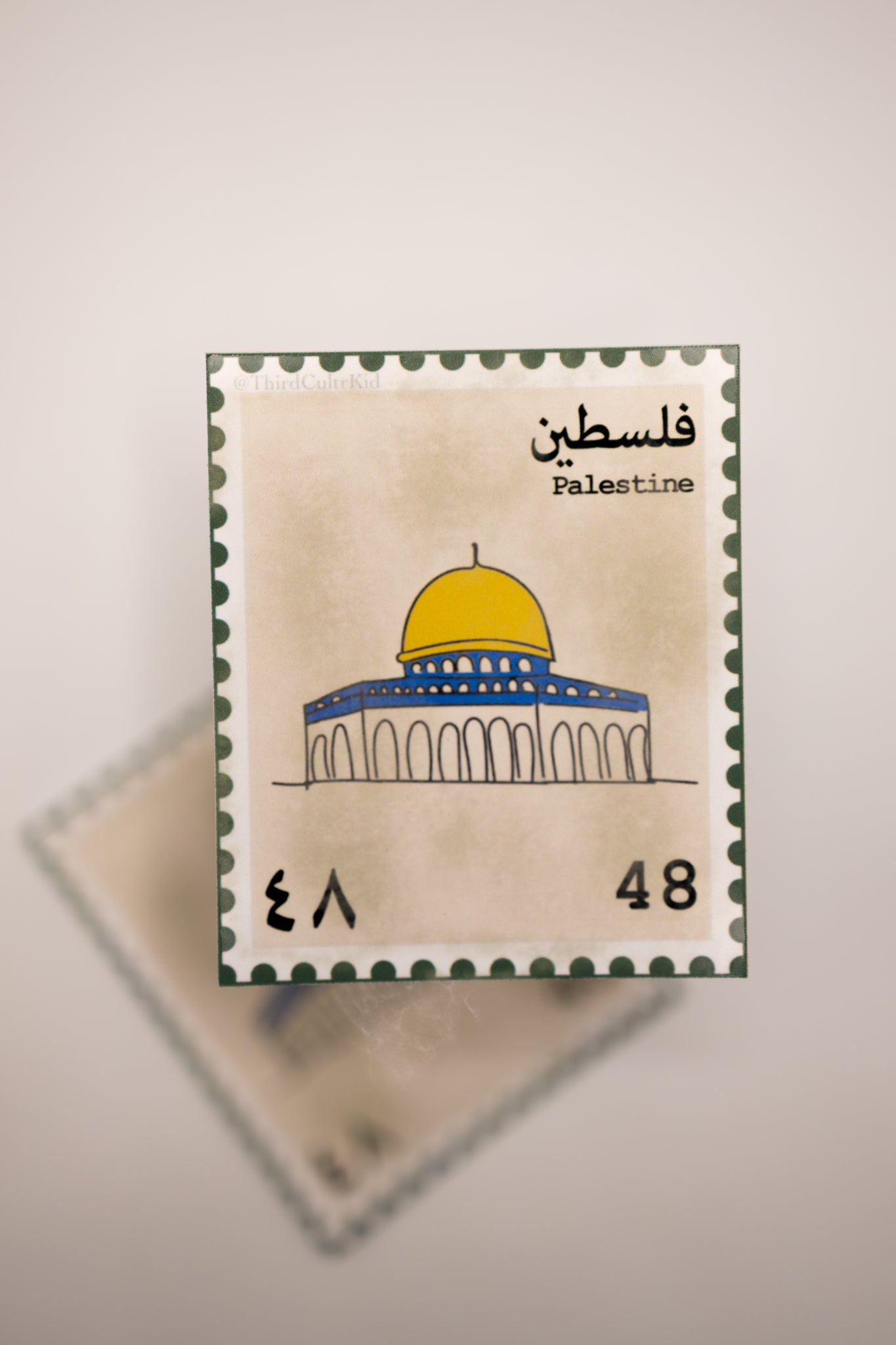 Stylized postage stamp design with a dome of the Rock and text 'Palestine' on a beige background.