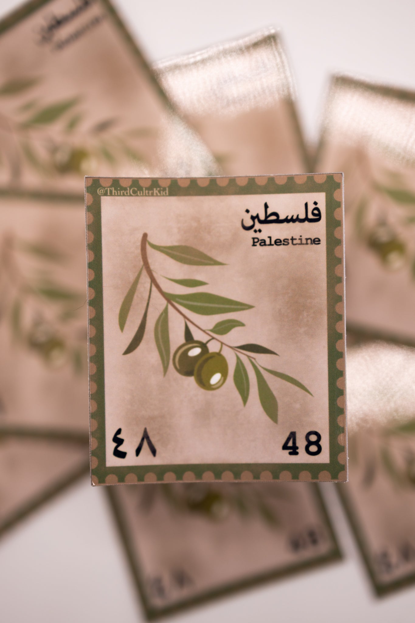 Stamps with olive branch design and text on a light background