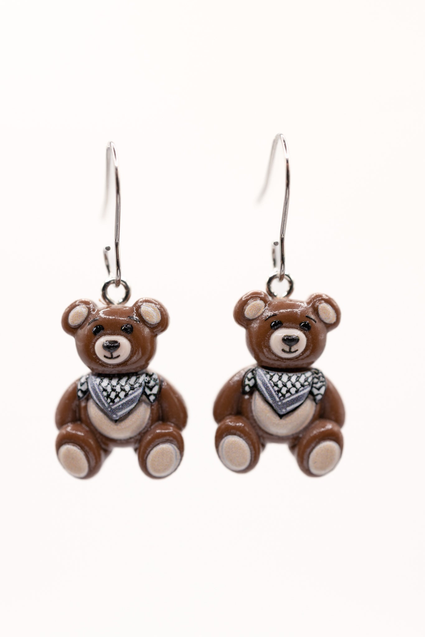Pair of teddy bear-shaped earrings with keffiyeh on a white background