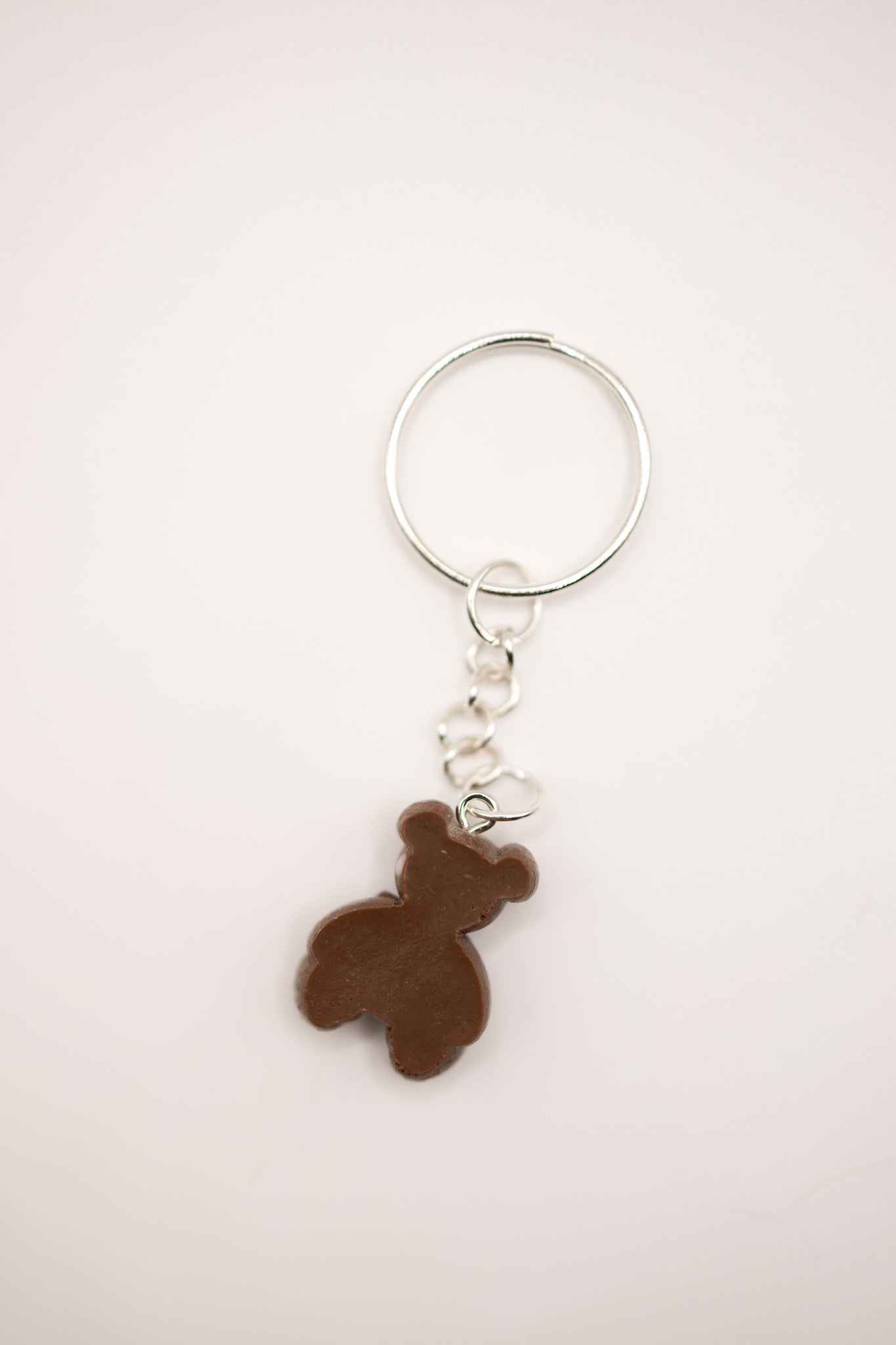 Keychain with a brown bear-shaped charm on a light gray background
