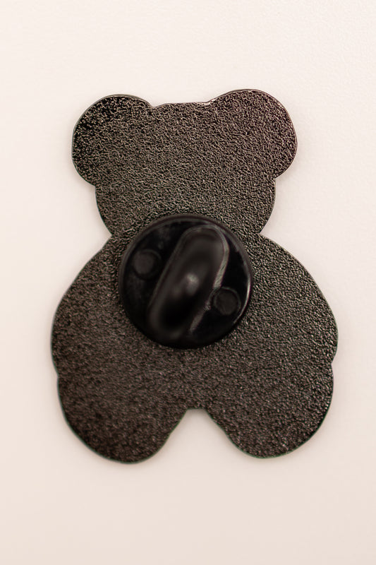 Black teddy bear-shaped object on a white background
