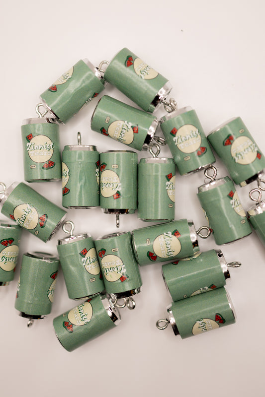 Collection of green cylindrical charms with 'zionist tears' text and decorative elements on a white background
