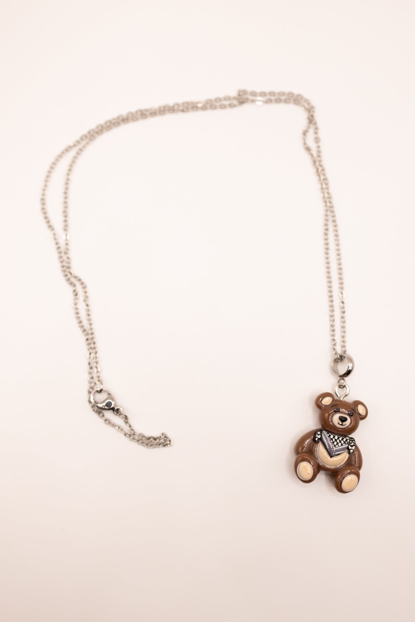 Necklace with a palestine bear pendant on a beige background