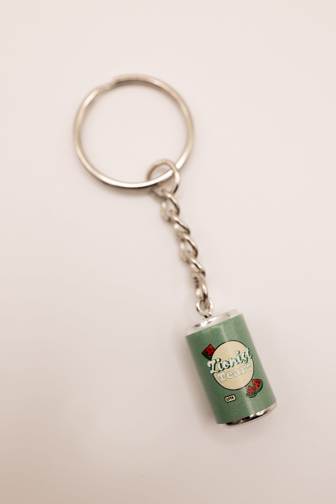 Keychain with a miniature can design that says "zionist tears" on a white background