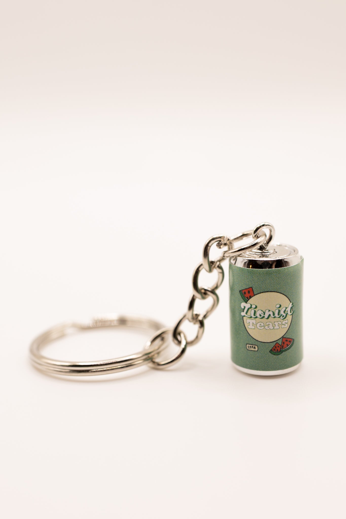 Keychain with a miniature can design that says "zionist tears" on a white background