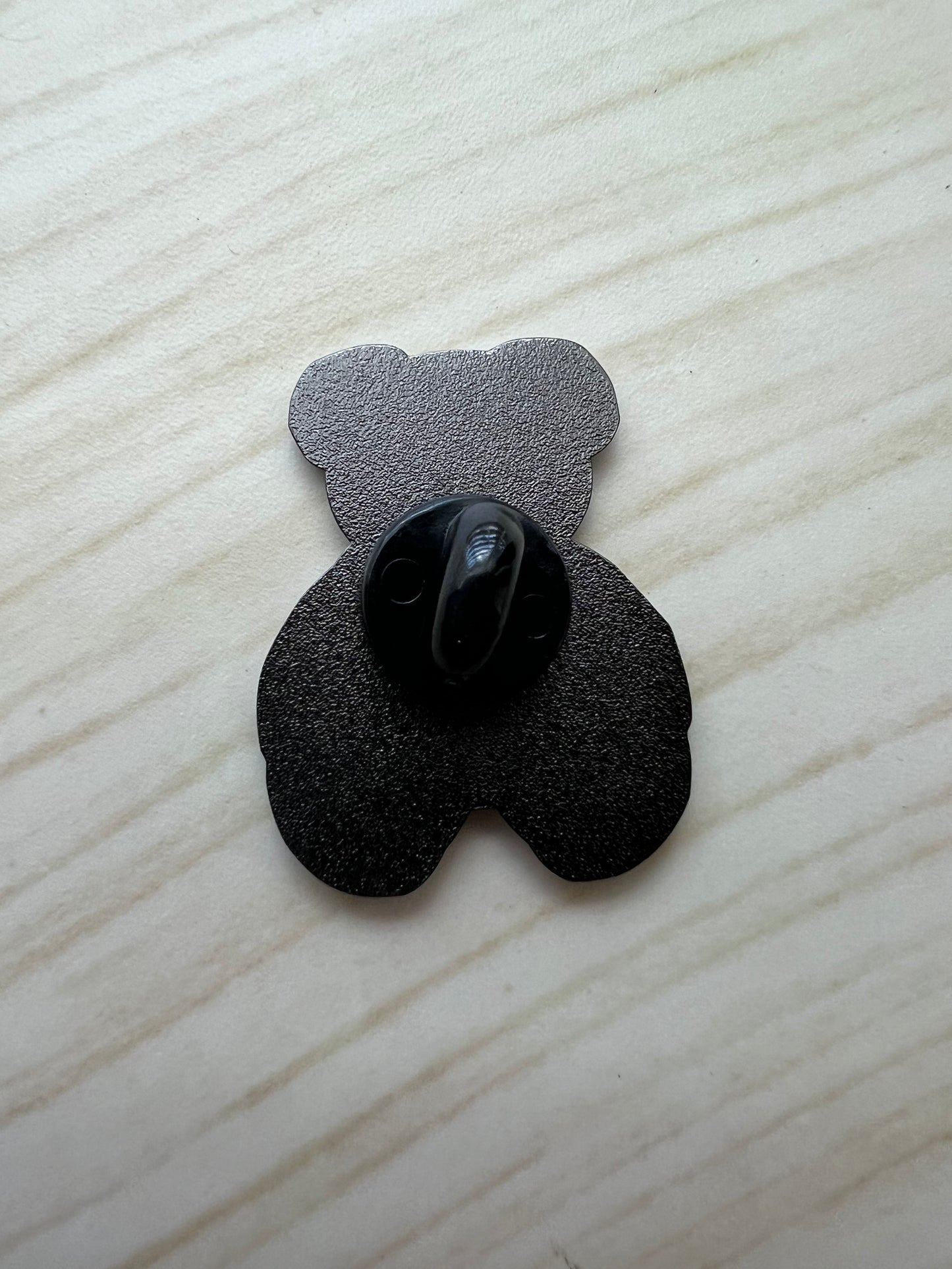 Black plastic component on a white textured surface
