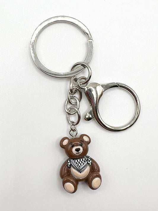 Keychain with a keffiyeh teddy bear charm on a white background