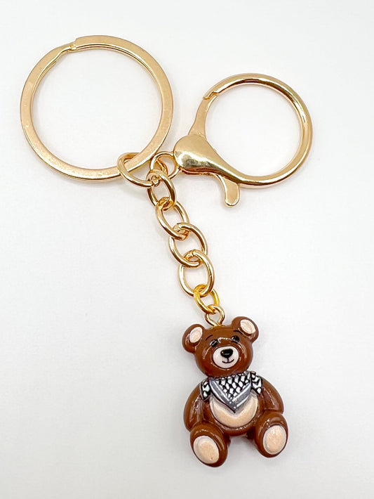 Keychain with a keffiyeh teddy bear charm on a white background