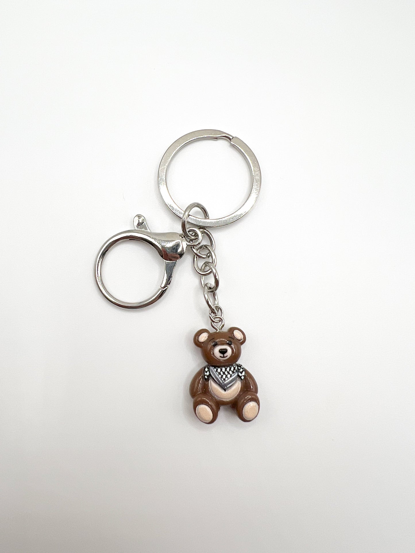 Keychain with a keffiyeh teddy bear charm on a white background