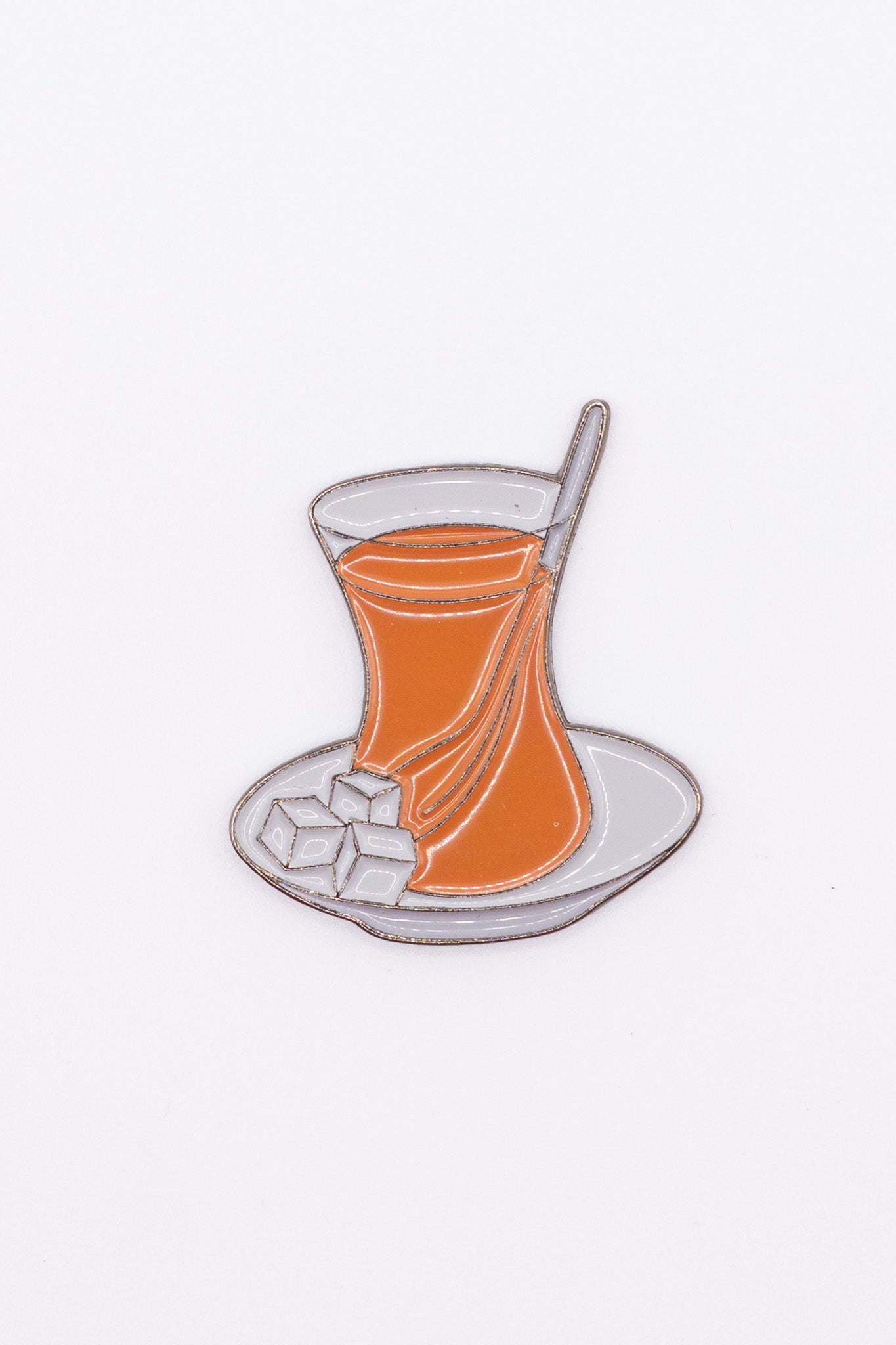 enamel sticker of a glass of Turkish cup or arabic tea with spoon and sugar cubes
