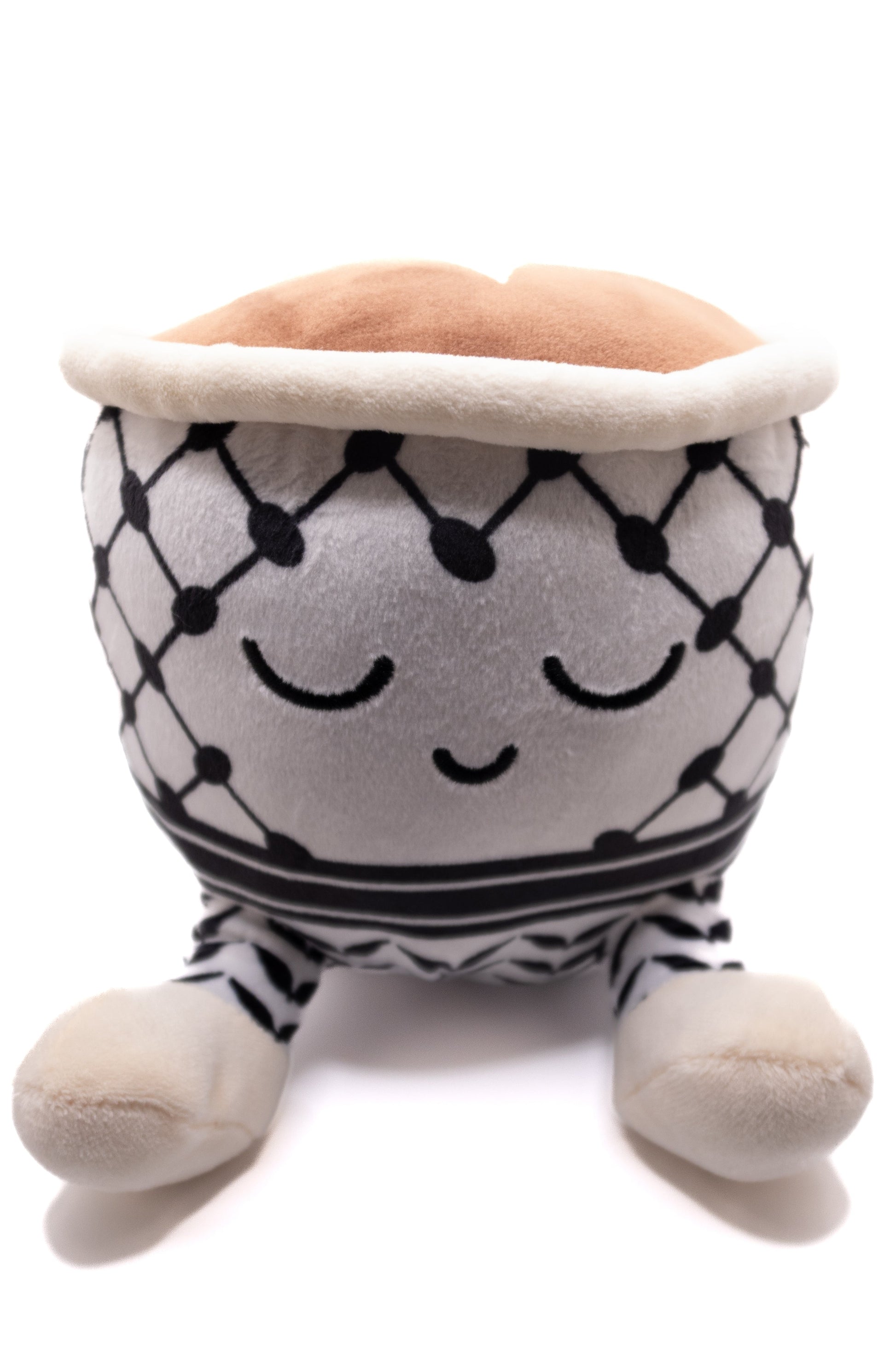 Plush toy Qahwa finjan with a face and keffiyeh pattern on a white background