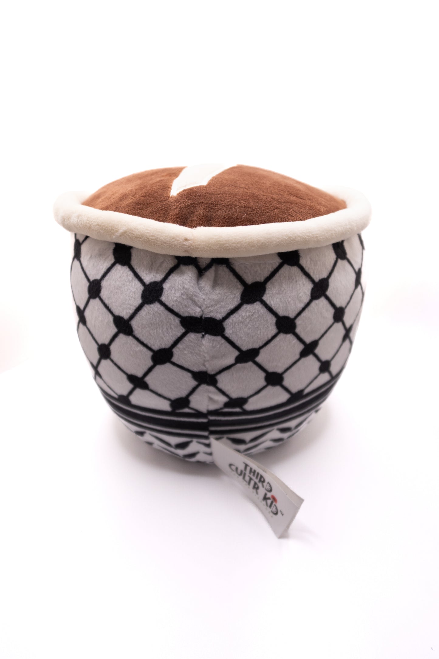 Plush toy Qahwa finjan with a face and keffiyeh pattern on a white background